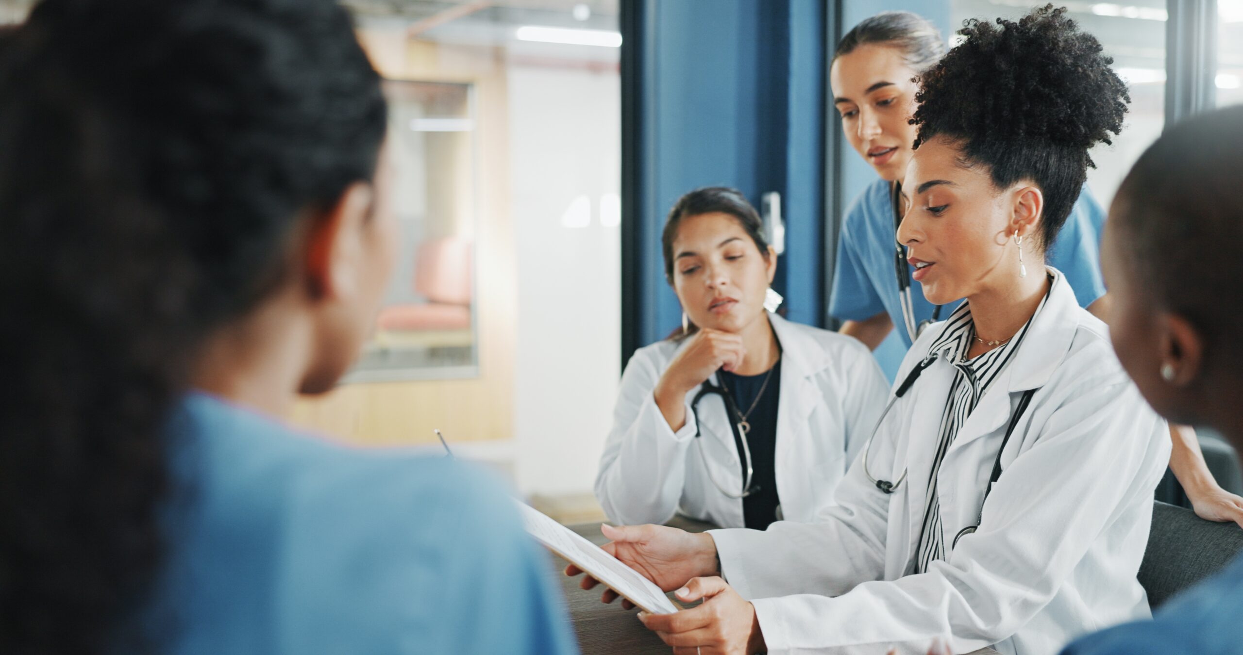 healthcare professionals looking at a clipboard