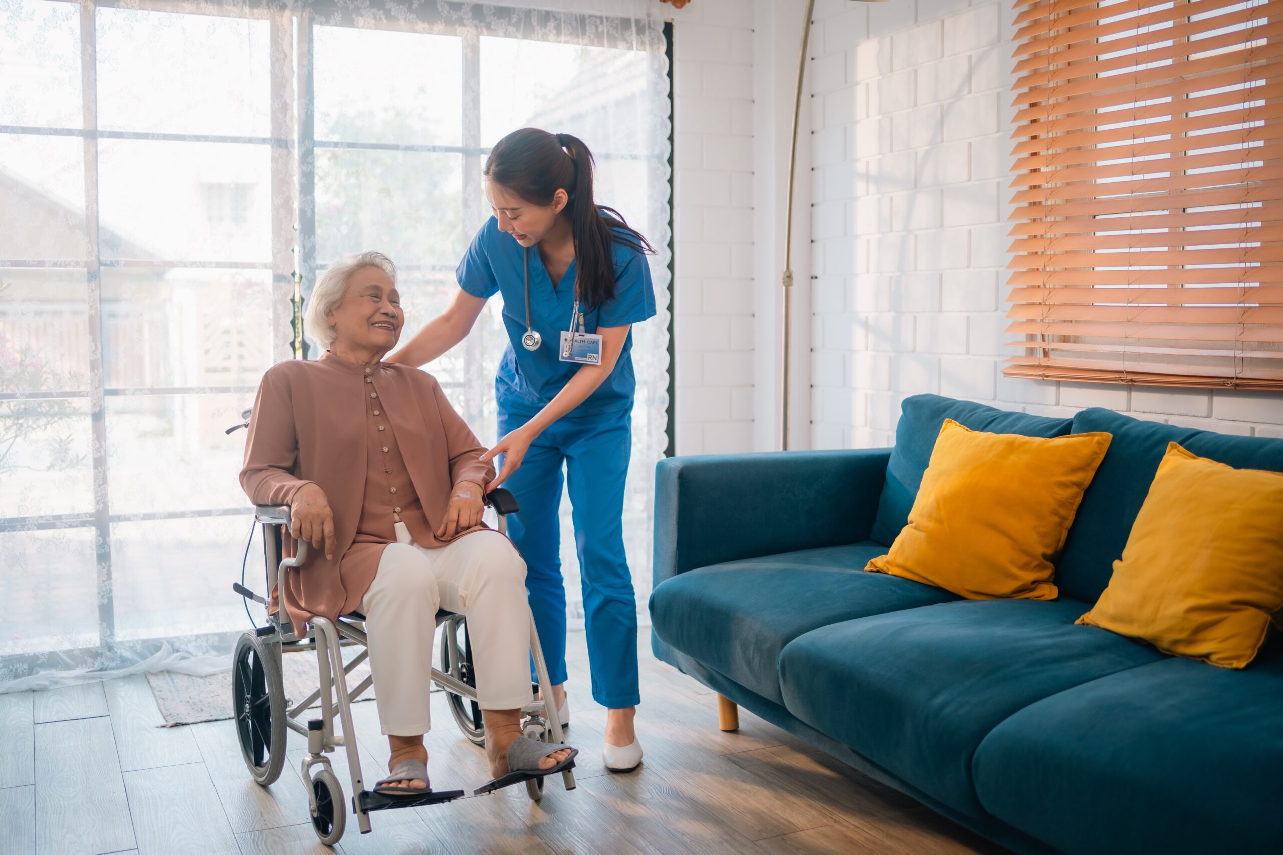 elderly women in wheelchair being helped by a nurse who learned safety practie from nursing policies and procedures