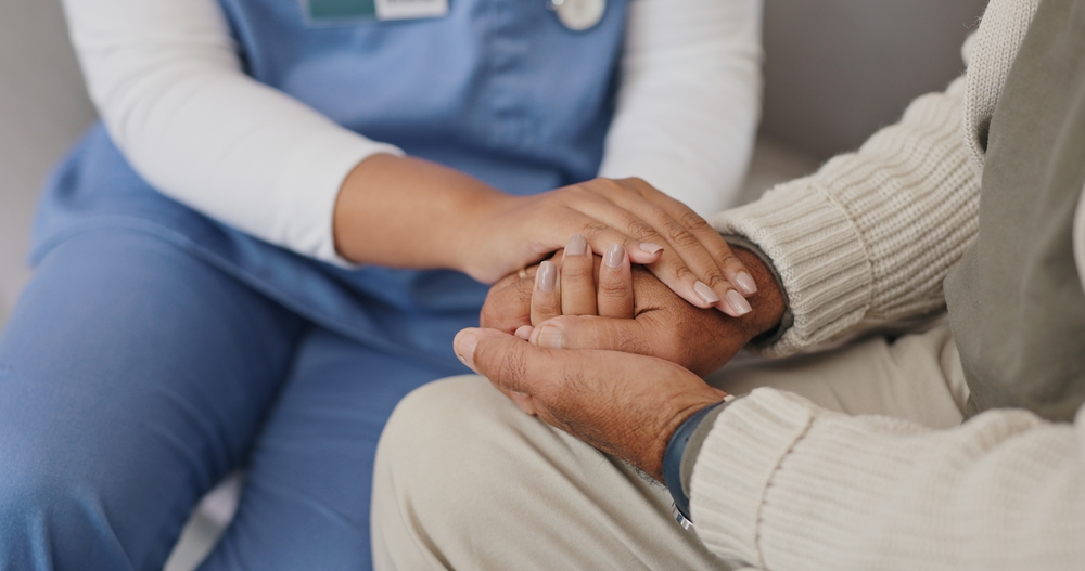 patients holding healthcare professionals hands